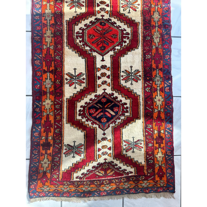 Vibrant red and cream Persian Meshgi wool runner with geometric designs