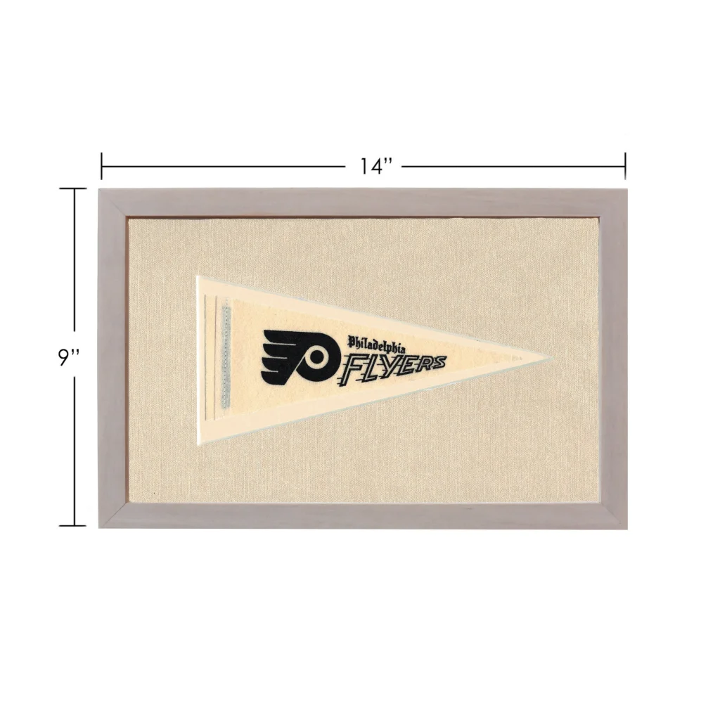 Vintage Philadelphia Flyers pennant in beige with black logo, framed