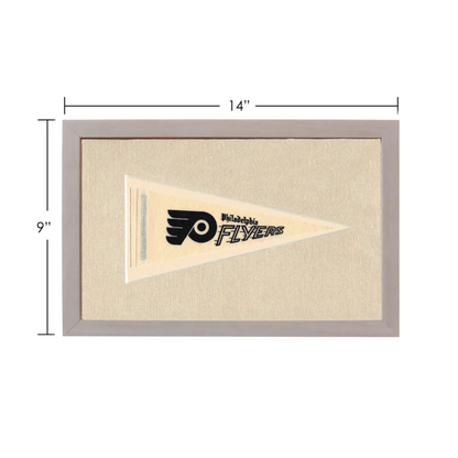 Vintage Philadelphia Flyers pennant in beige with black logo, framed