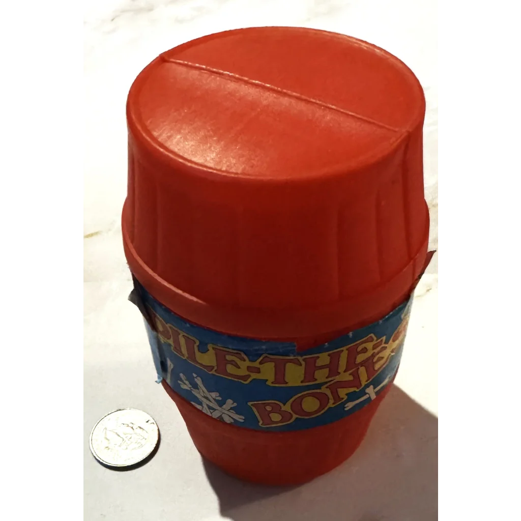 Red plastic thermos with blue Rhythm Pax Box label beside Vintage Pile The Bones Game