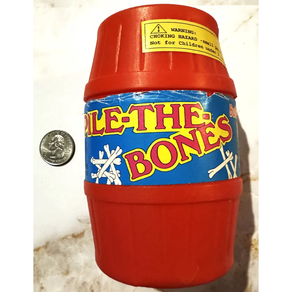 Red barrel toy container for Vintage Pile The Bones Game with a warning sticker