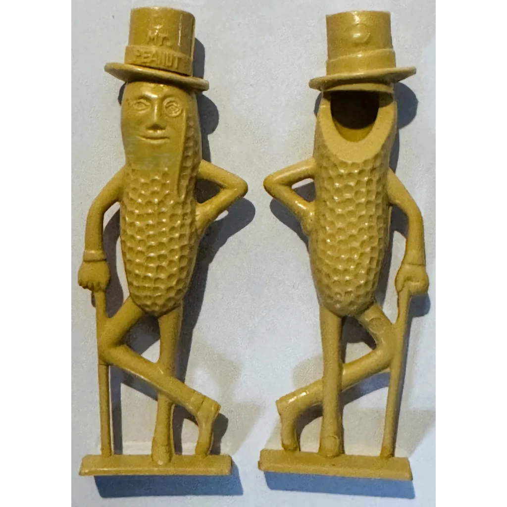 Vintage 1950s Mr. Peanut whistle collectible with golden-yellow cast iron peanuts in top hats