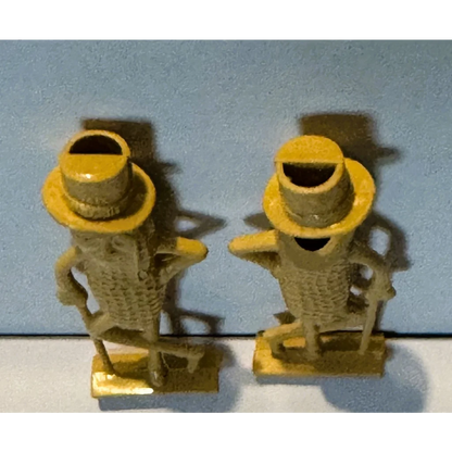 1950s Mr. Peanut whistle collectible: yellow cast iron figurines with hats and cane