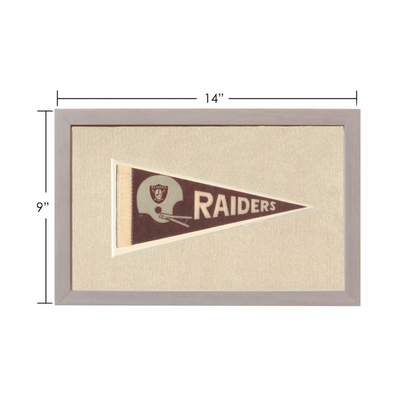 Vintage Raiders pennant framed with brown background