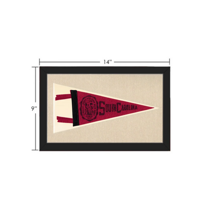 A vintage south carolina pennant in maroon and cream felt with embroidered lettering and logo framed for display