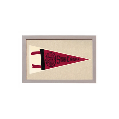 Framed vintage south carolina pennant with maroon and cream embroidered fabric featuring collegiate lettering and logo