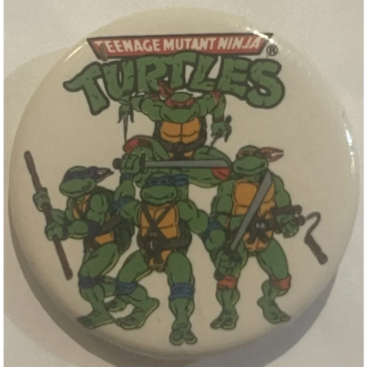 Circular button with Teenage Mutant Ninja Turtles logo and characters for collectors