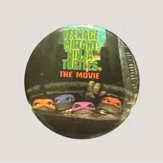Vintage Teenage Mutant Ninja Turtles movie button collectible featuring Teenage Mutant Ninja Turtles icon