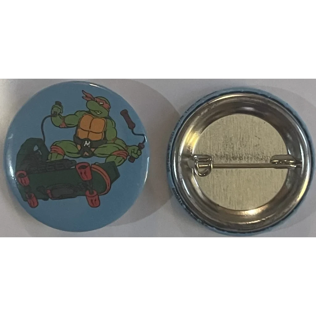 Cartoon button pin of a skateboarding Teenage Mutant Ninja Turtle Michelangelo