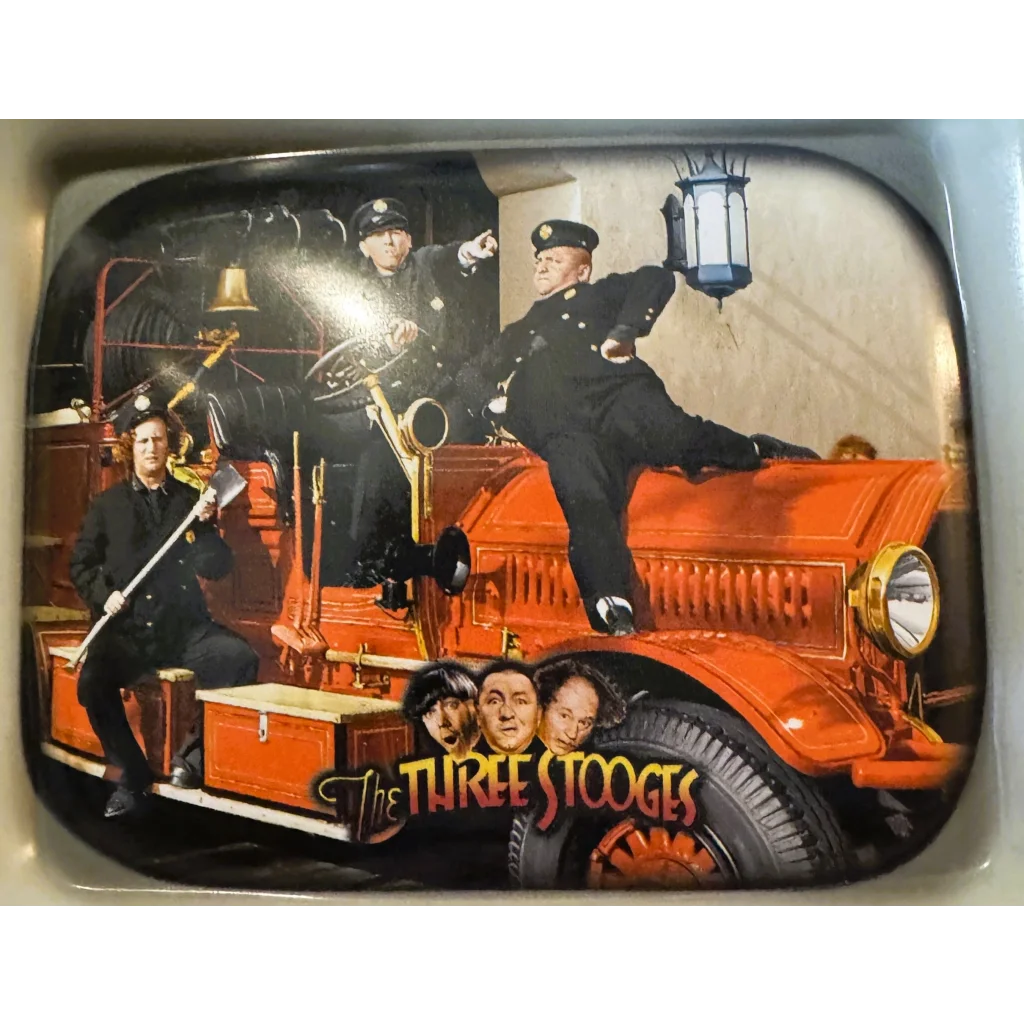 Orange vintage fire truck lunch box from 1999 featuring Three Stooges classic design