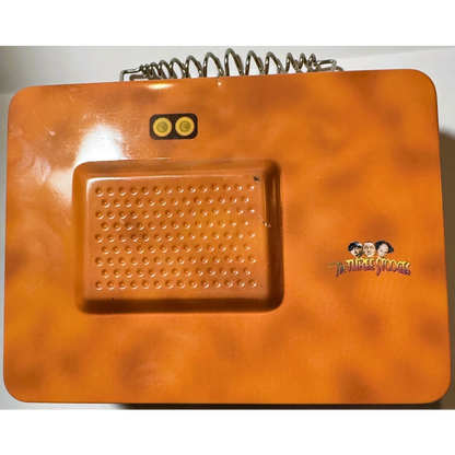 Orange vintage toy telephone with spring cord, part of the Three Stooges lunch box collection