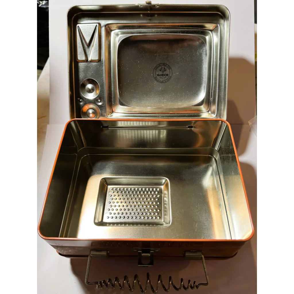 Vintage Three Stooges lunch box with retro TV shape, orange accents, and silver details