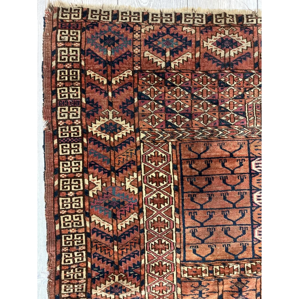 Vintage Turkmen geometric rug in rust, navy, and cream tones