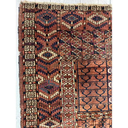 Vintage Turkmen geometric rug in rust, navy, and cream tones
