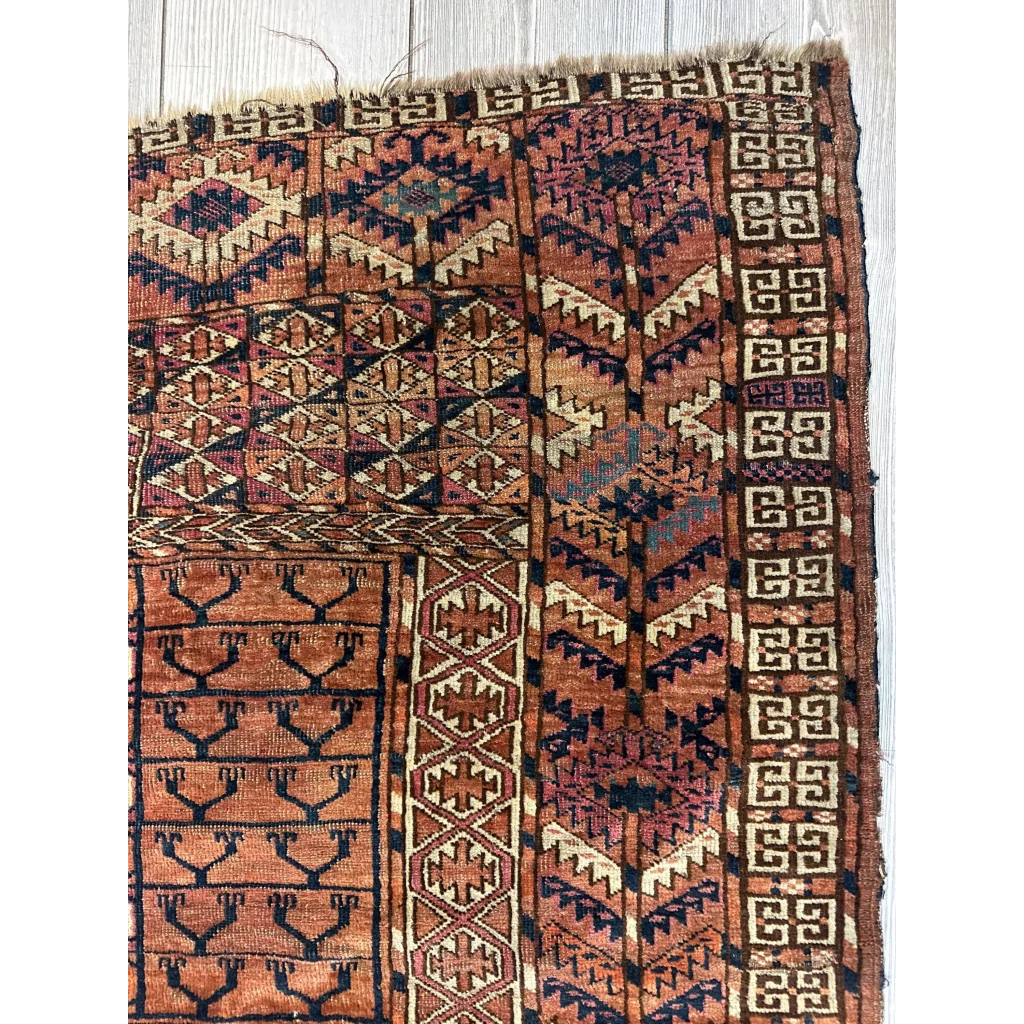 Antique Turkmen Ensi tent-door rug with geometric patterns in rust, navy and cream