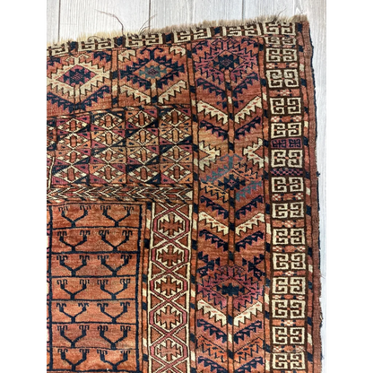Antique Turkmen Ensi tent-door rug with geometric patterns in rust, navy and cream