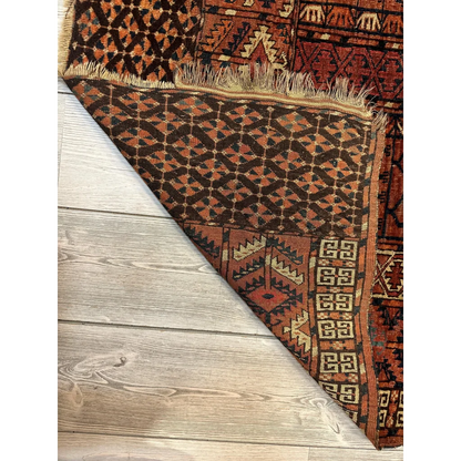 Vintage Turkmen geometric rug in rich earthy tones with fringe
