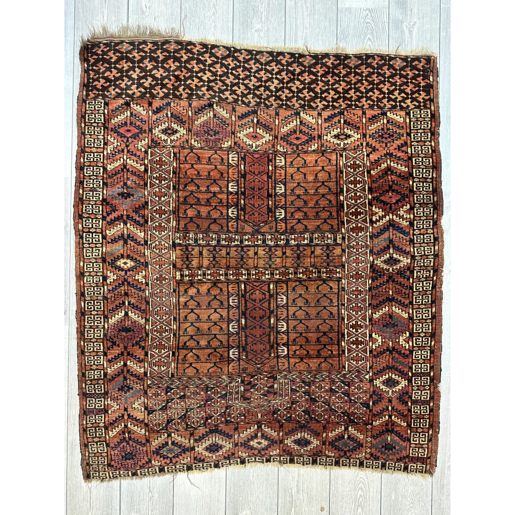Antique Turkmen Ensi rug in rust, terracotta and brown tones with geometric designs