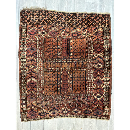 Antique Turkmen Ensi rug in rust, terracotta and brown tones with geometric designs