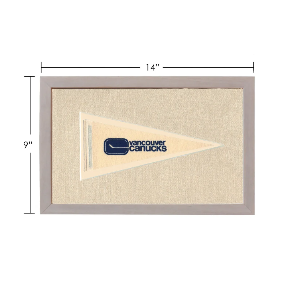Vintage Vancouver Canucks pennant in beige frame with navy logo