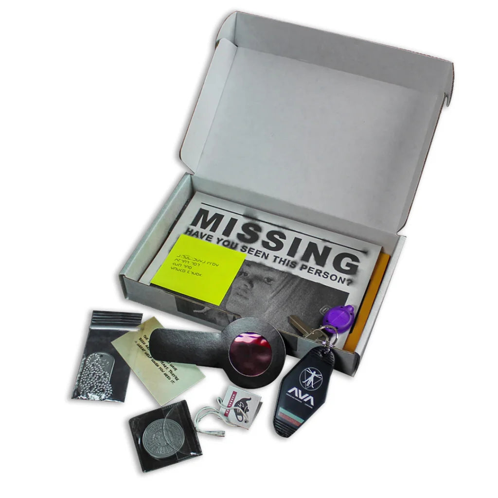 White cardboard box with mystery game components from Vivian Deluxe Edition by Angels & Airwaves