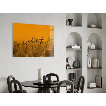 Orange wanderlust glass wall art with black cursive over golden cityscape