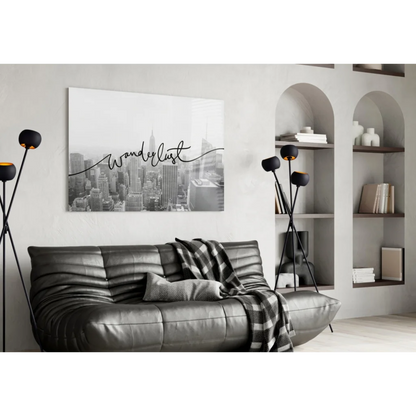 Black leather sofa with ribbed texture and plaid throw near wall art