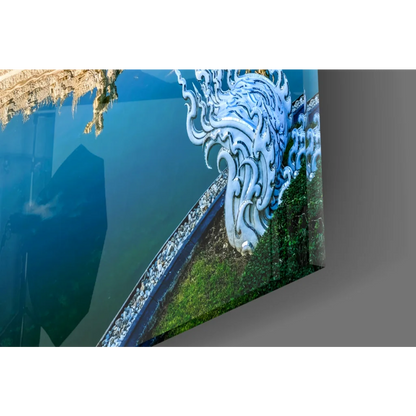 Vibrant ornate white dragon glass wall art print reflected in blue water