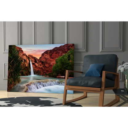 Vibrant glass wall art of waterfall through red canyon cliffs at sunset
