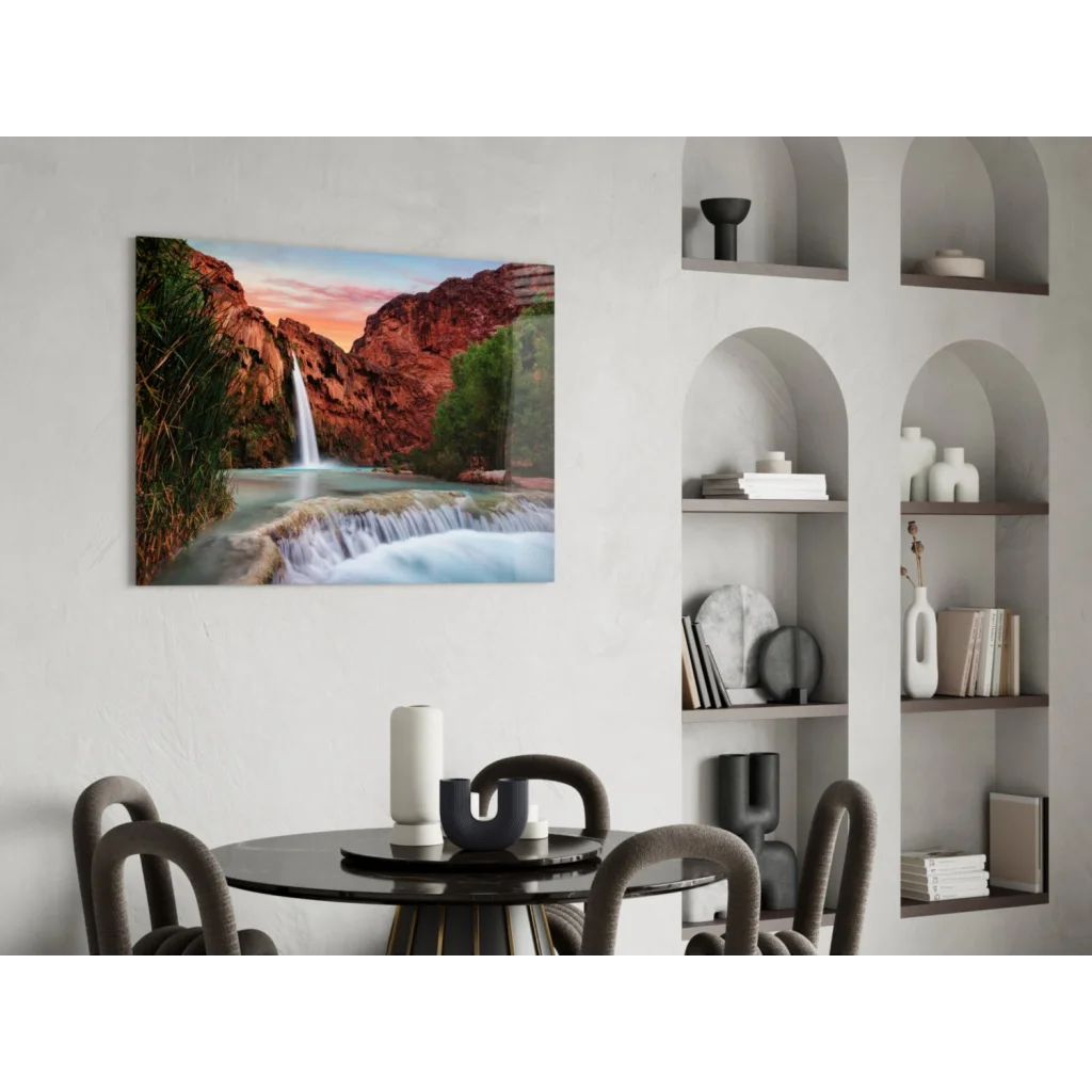Vibrant glass wall art of waterfall cascading through red canyon cliffs at sunset
