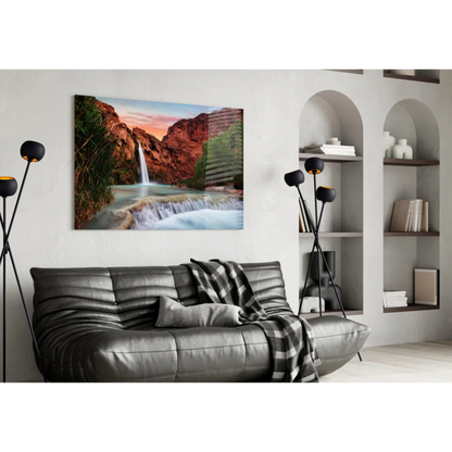 Vibrant sunset waterfall glass wall art on red canyon cliffs