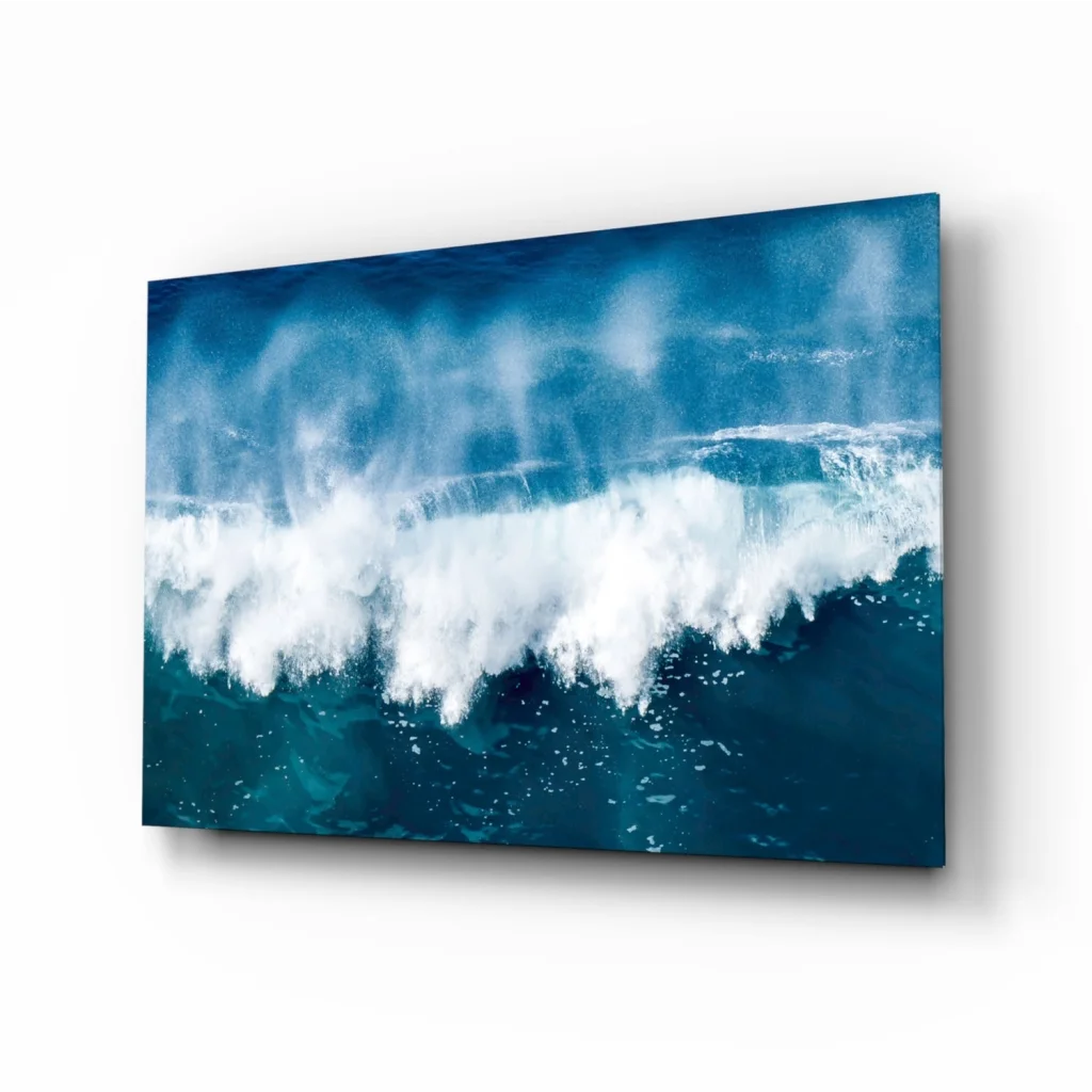 Vibrant blue ocean wave glass wall art with white foam and teal hues