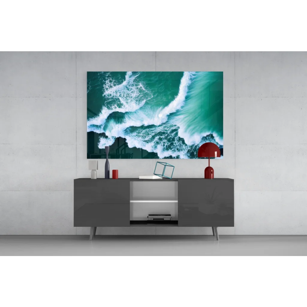 Vibrant teal ocean wave glass wall art on gray console