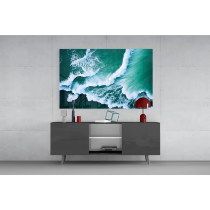Vibrant teal ocean wave glass wall art on gray console