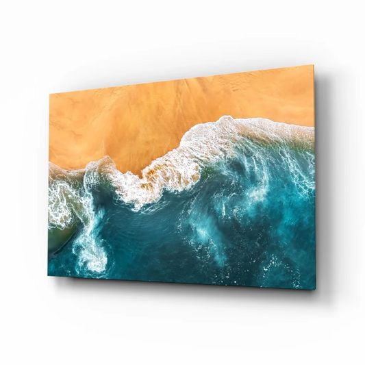 Vibrant turquoise waves crashing on golden sand in glass wall art print