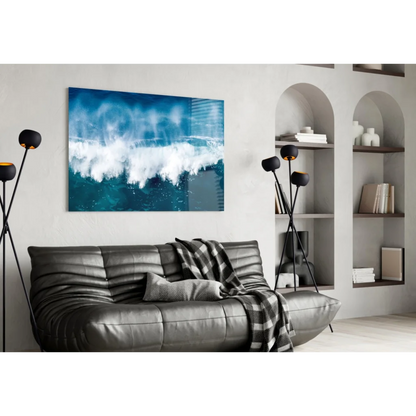 Stunning blue wave glass wall art above gray leather sofa