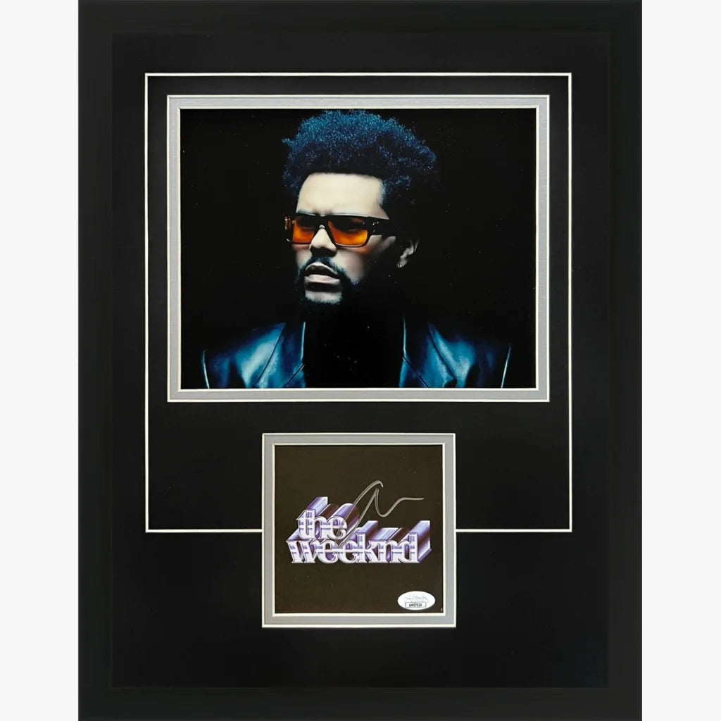 Black-framed weeknd autographed dawn fm deluxe portrait with orange sunglasses and blue hair on dark background