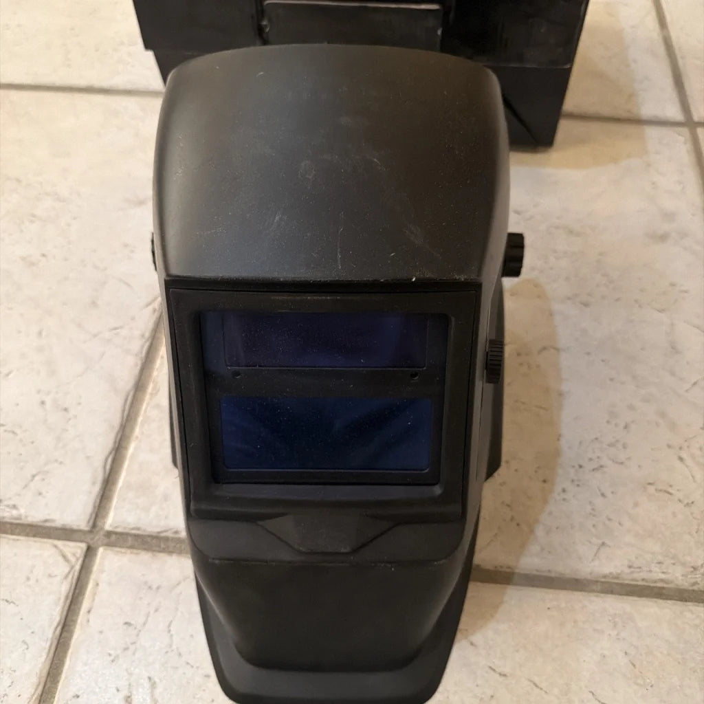 Chicago Electric black welding helmet with dark blue visor and knobs