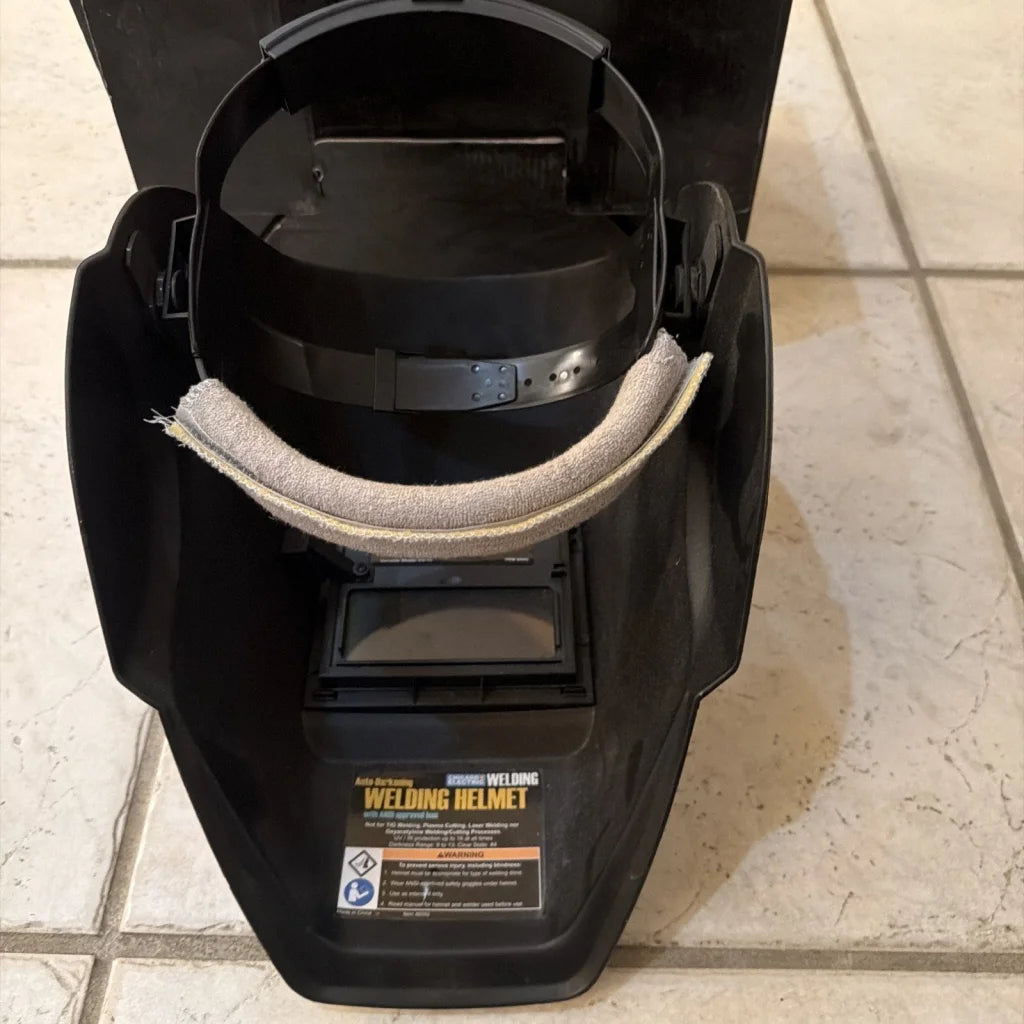 Chicago Electric black auto-darkening welding helmet with beige chin strap