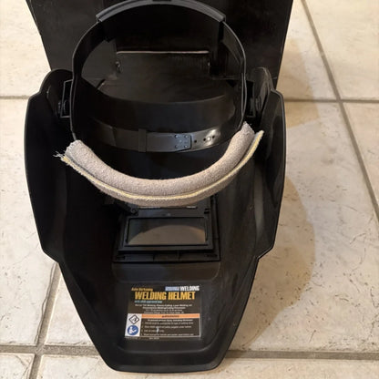 Chicago Electric black auto-darkening welding helmet with beige chin strap