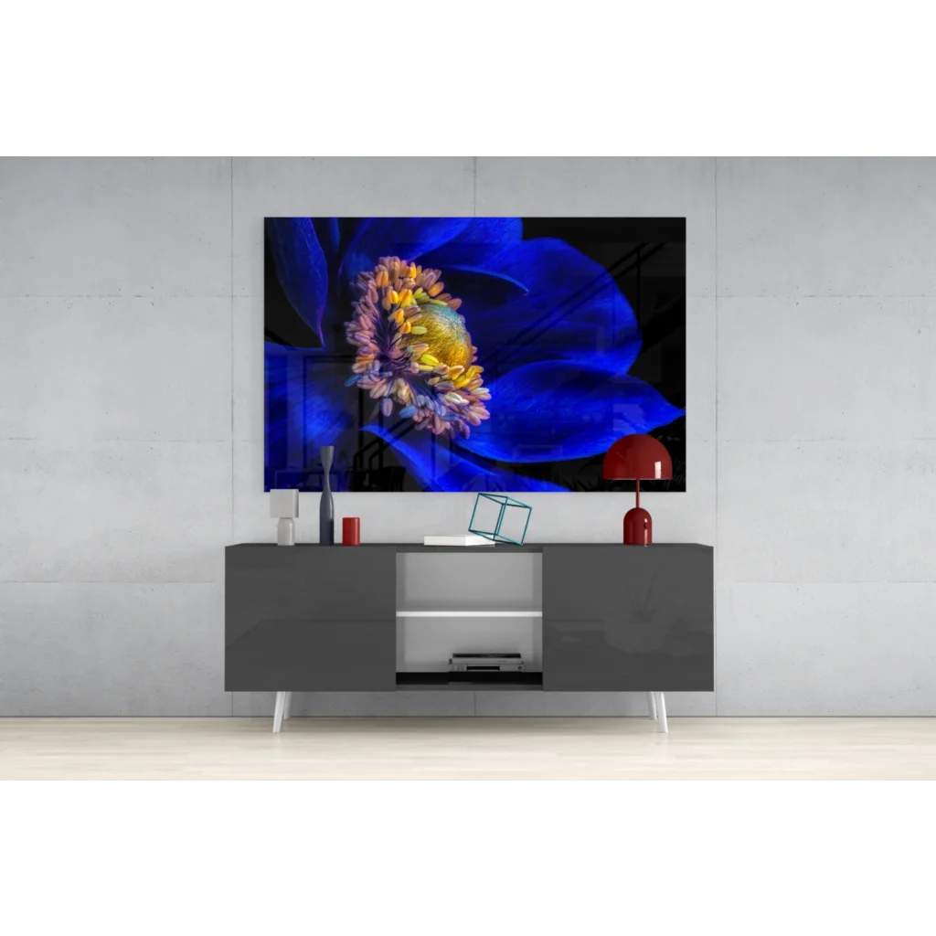 Vibrant blue and yellow glass wall art on black canvas atop gray console