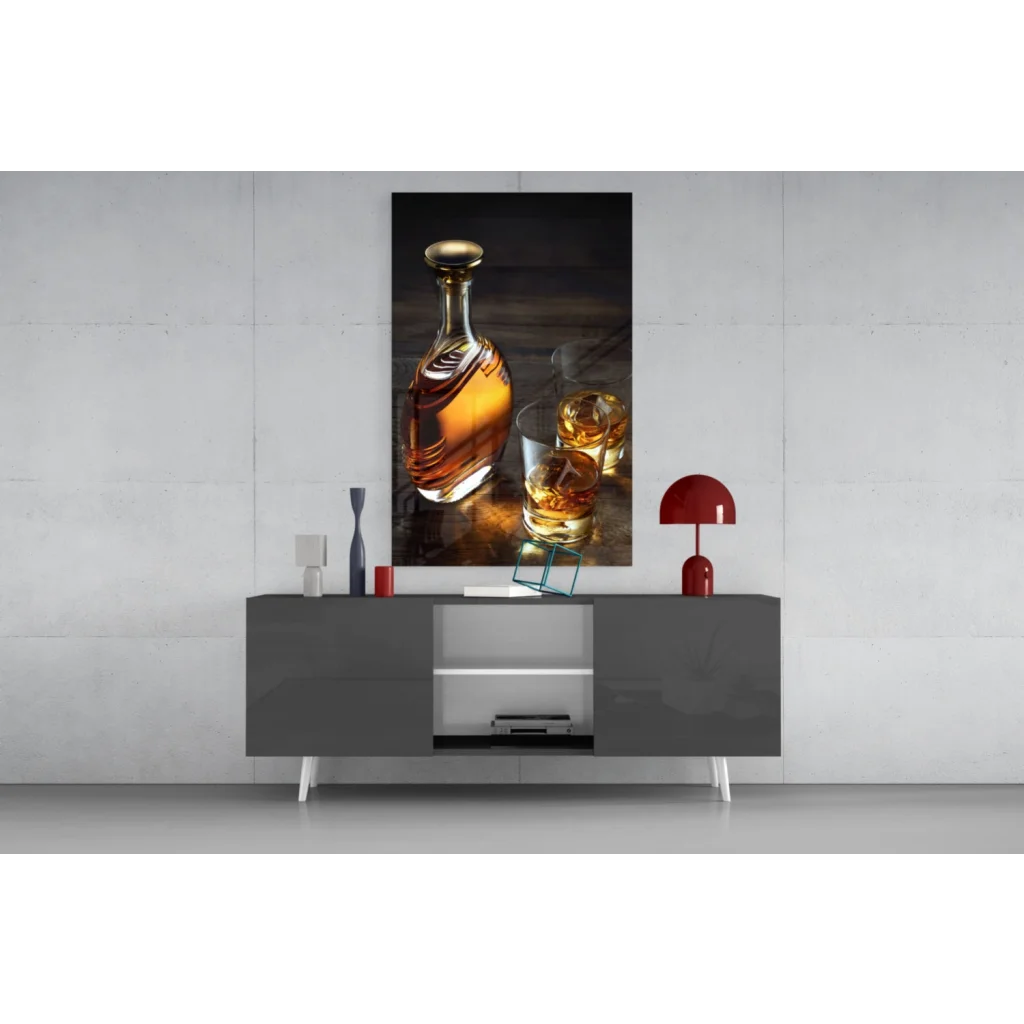 Sleek gray console table with white legs under whiskey decanter glass wall art
