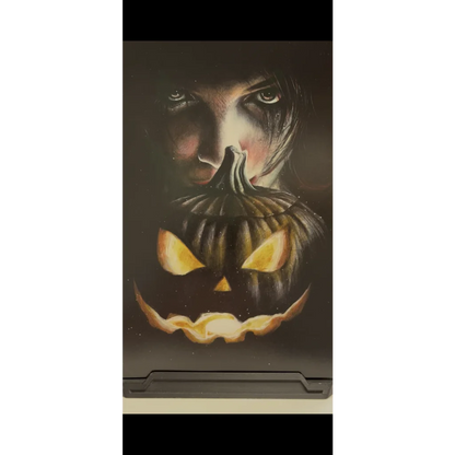 Glow-in-the-dark Wil Shrike black jack o lantern with carved face and glowing eyes