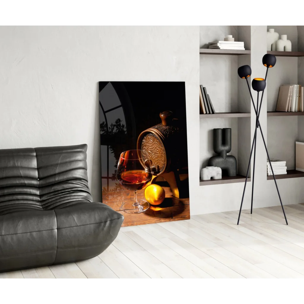 Black-framed glass wall art print with amber liquid, golden decanter, citrus fruit
