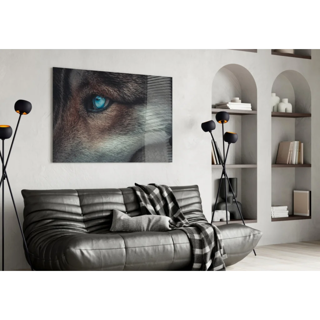 Piercing blue wolf eye canvas wall art print on black sofa