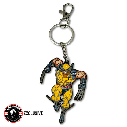 Front view of a metal Wolverine keychain, yellow-suited figure with silver claws, Unknown Comics Exclusive badge at lower left.