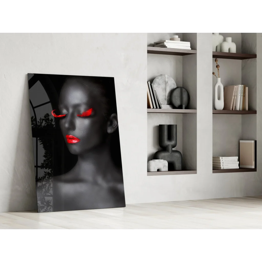 Striking black-and-white glass wall art of woman with red lips and eyes on white wall