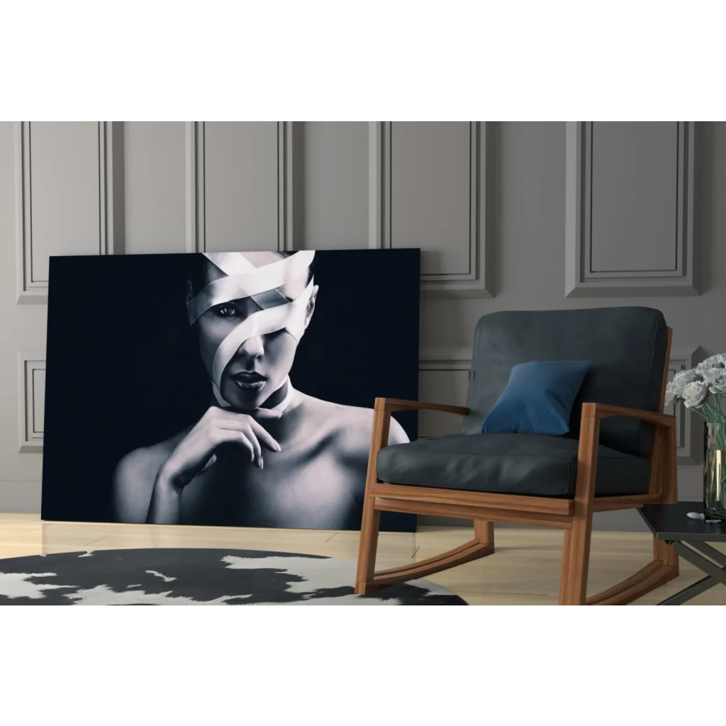Black-and-white glass wall art portrait of woman with white tape face wrap