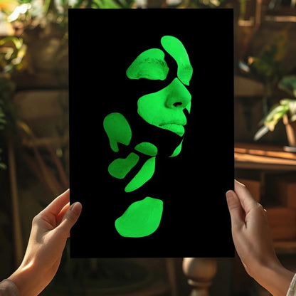 Glowing green abstract face on insigne aluminum print held by hands