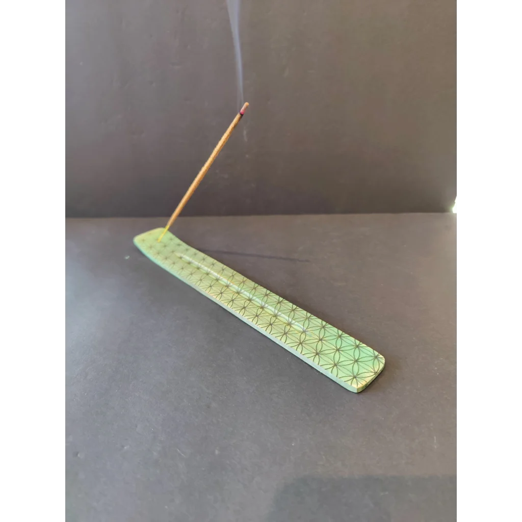 Light green wood printed incense burner with geometric pattern and burning stick